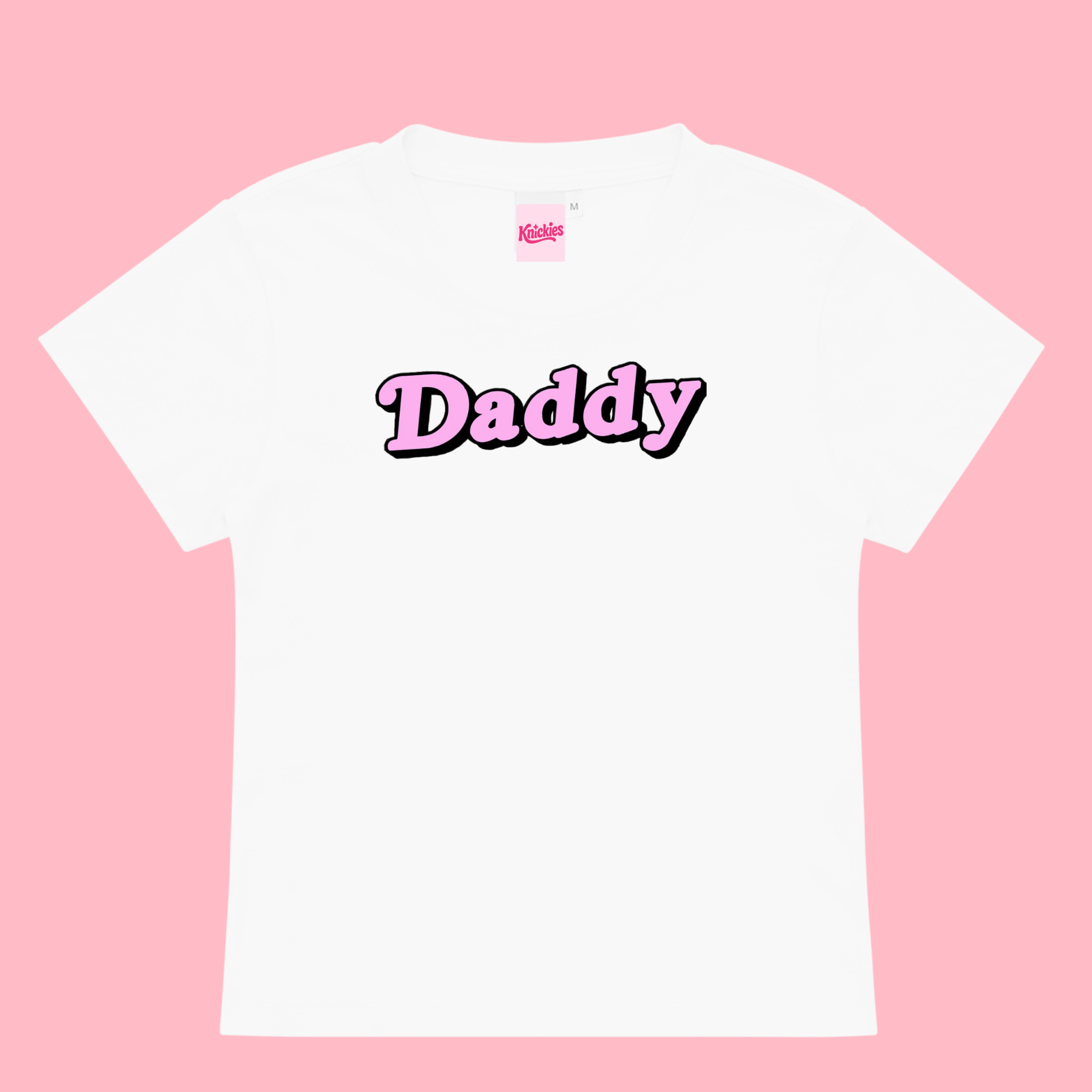 White t-shirt with 'Daddy' printed on it against a pink background