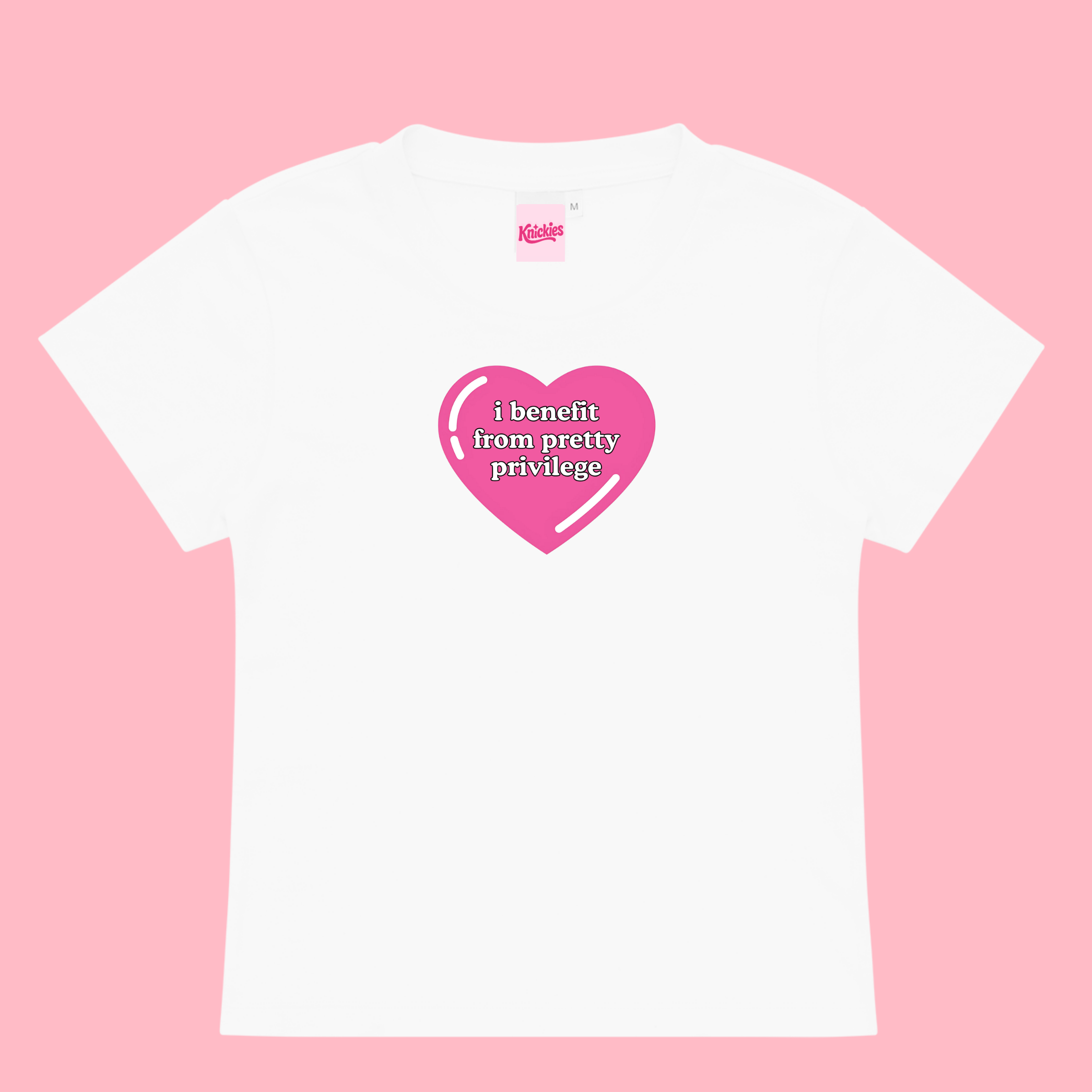 White t-shirt with pink heart graphic and text on a pink background
