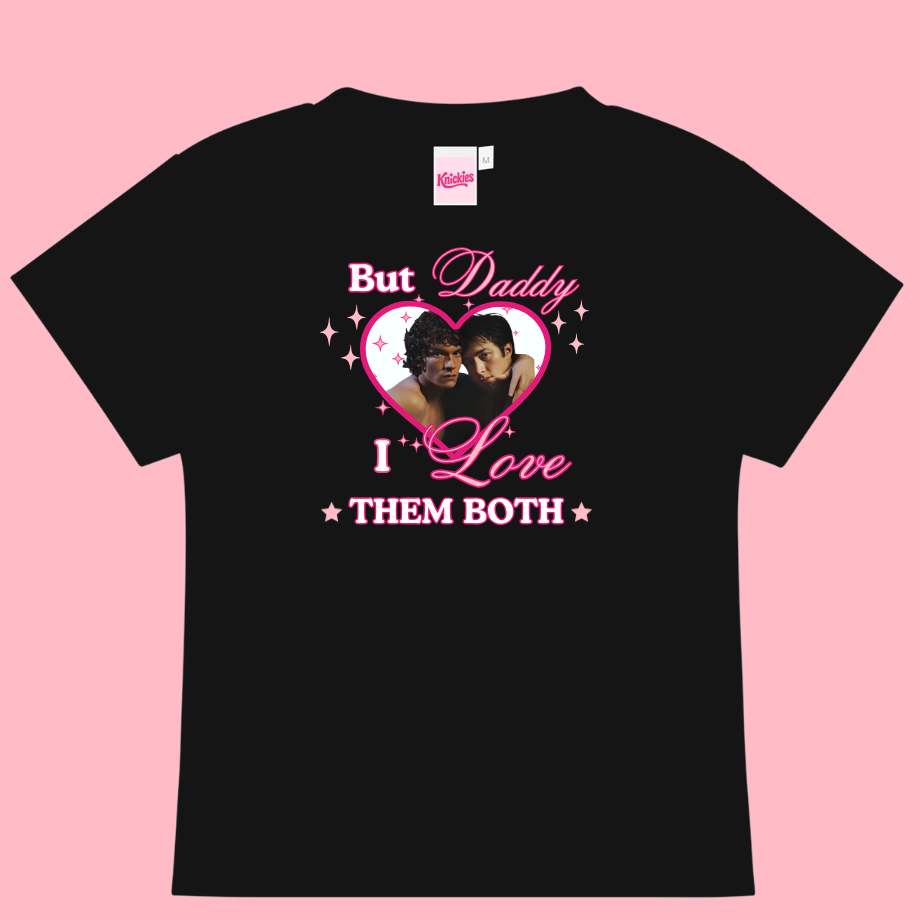 Black t-shirt with graphic design and text on a pink background