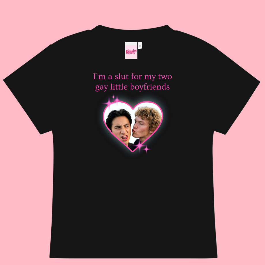 Black t-shirt with graphic design and text on a pink background