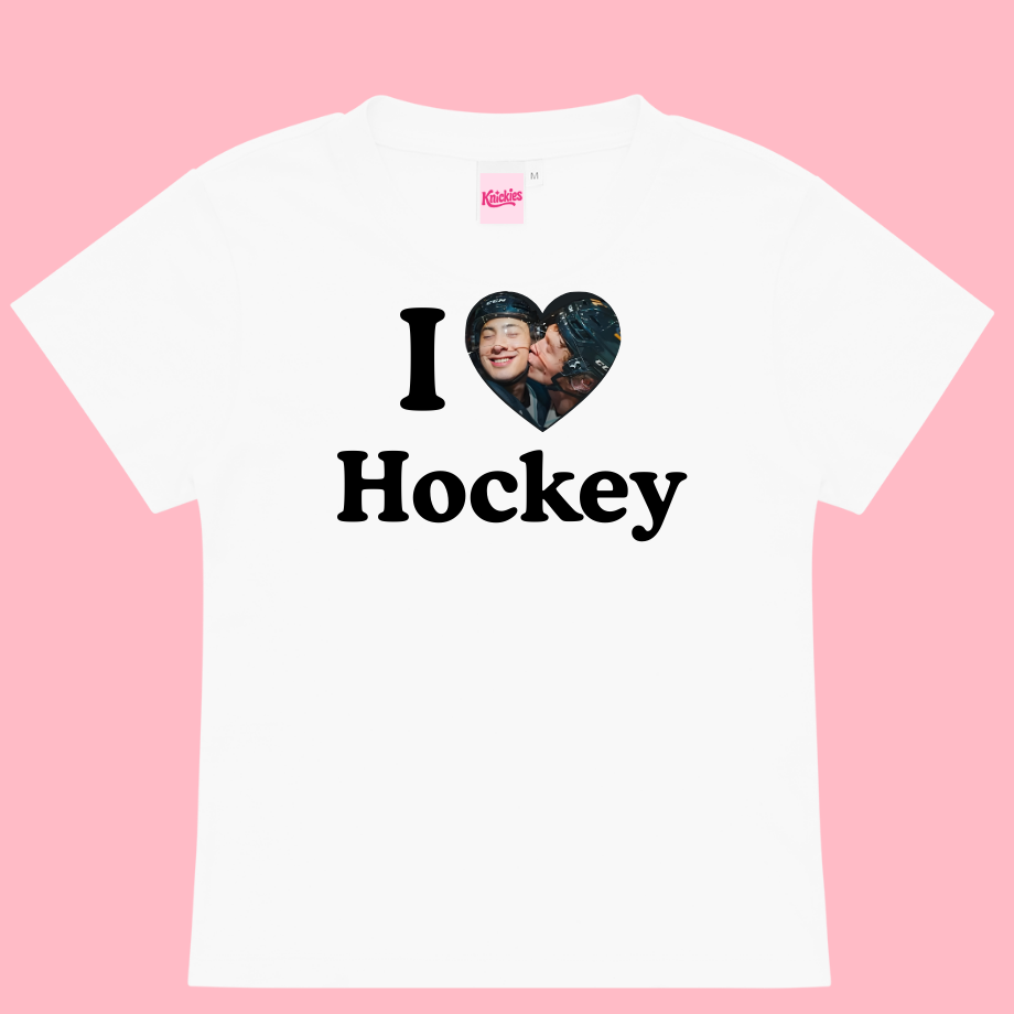 White t-shirt with 'I ❤️ Hockey' text and heart-shaped graphic on a pink background