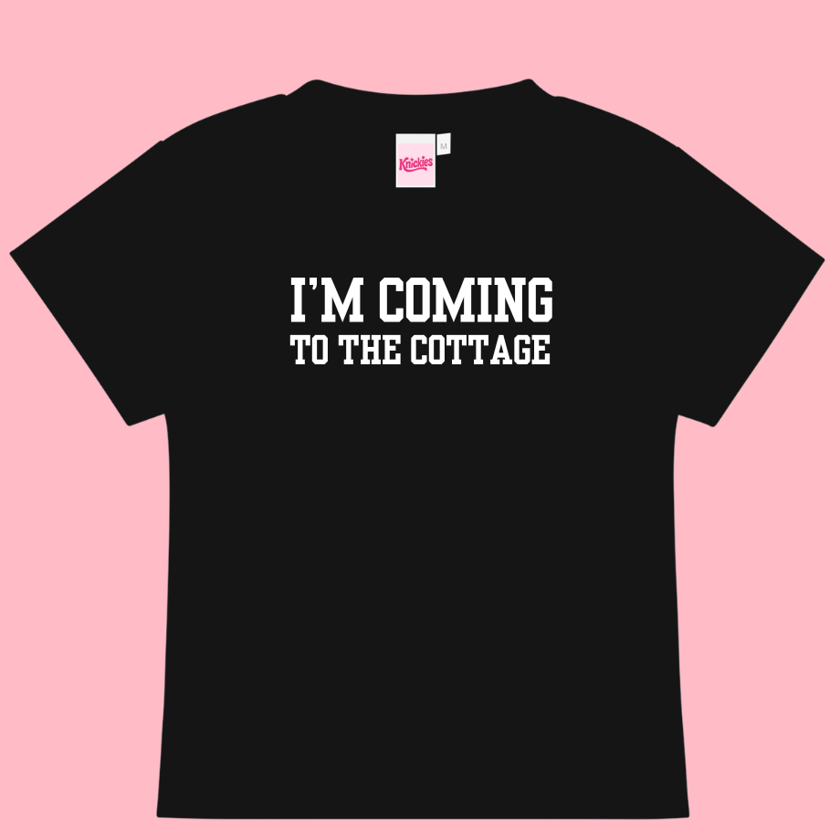 Black t-shirt with 'I'm Coming to the Cottage' text on a pink background