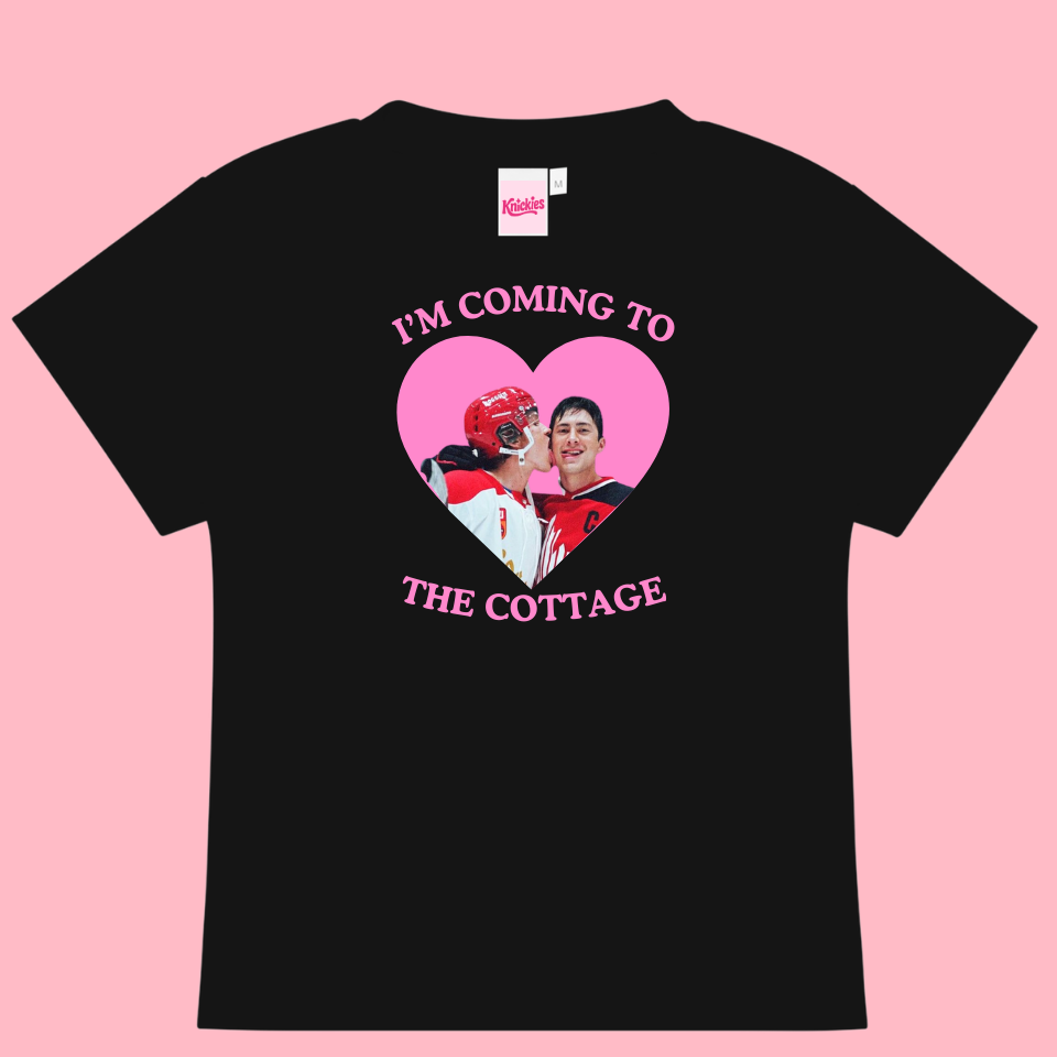 Black t-shirt with a heart-shaped graphic and text on a pink background