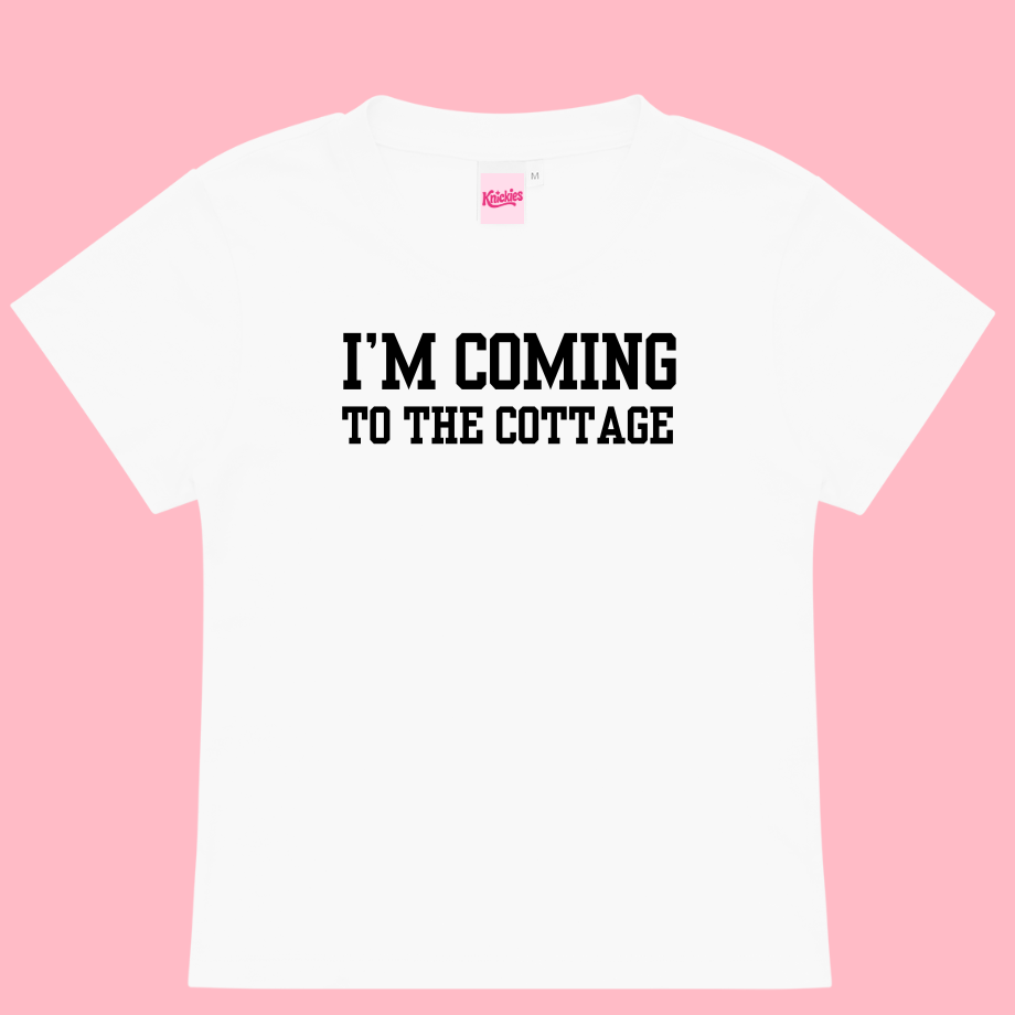 White t-shirt with 'I'm Coming to the Cottage' text on a pink background