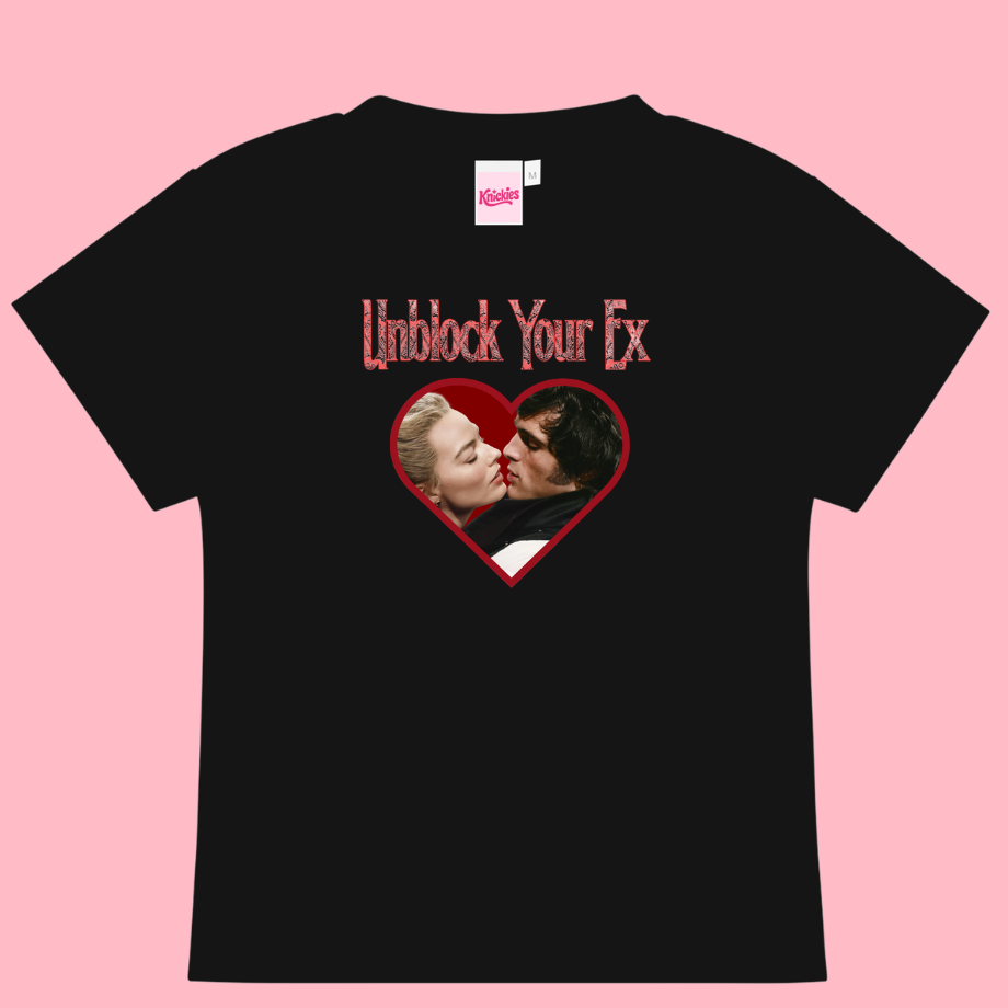 Black t-shirt with graphic design and text on a pink background