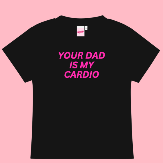 Black t-shirt with pink text 'YOUR DAD IS MY CARDIO' on a pink background